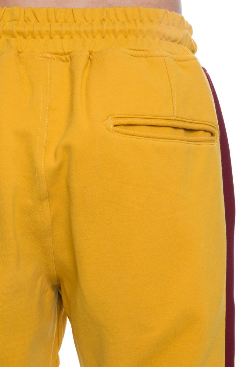 mustard track pants