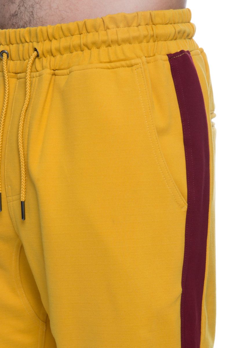 mustard track pants