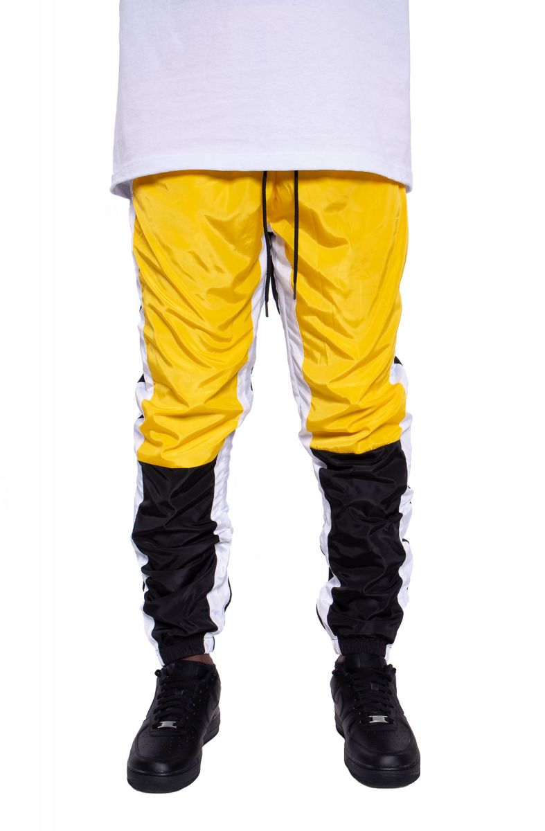 yellow black and white track pants