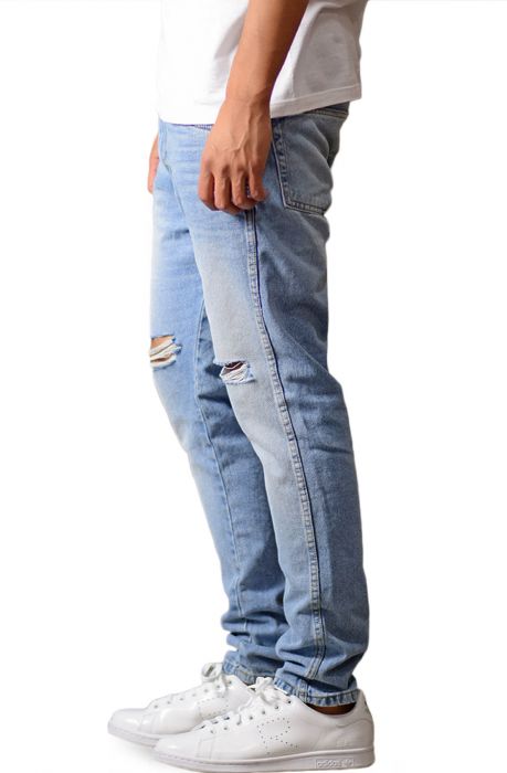 The Tapered Ripped Denim Jeans in Faded Indigo