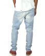 The Light Stonewashed Ripped Tapered Denim Jeans in Light Blue 3